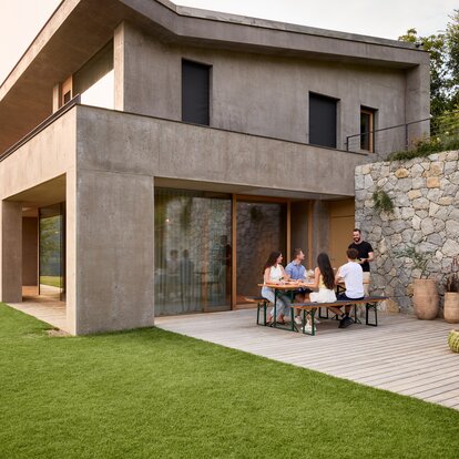 Several people sit at the beer garden table and spend a convivial evening.